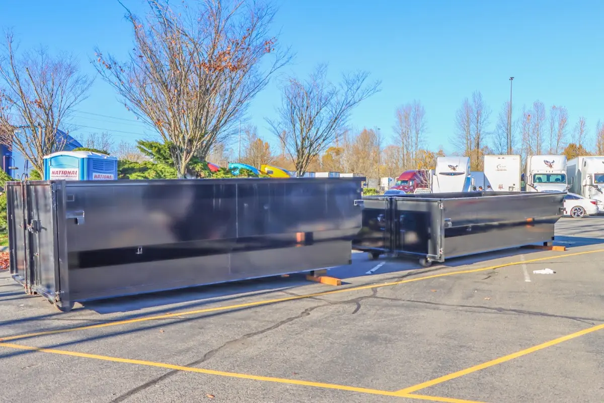 Professional dumpster rental service with roll-off container on residential driveway in Sparks